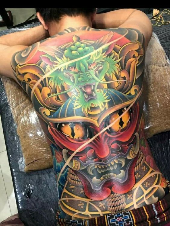 tattoo bít lưng mặt quỷ và rồng xanh